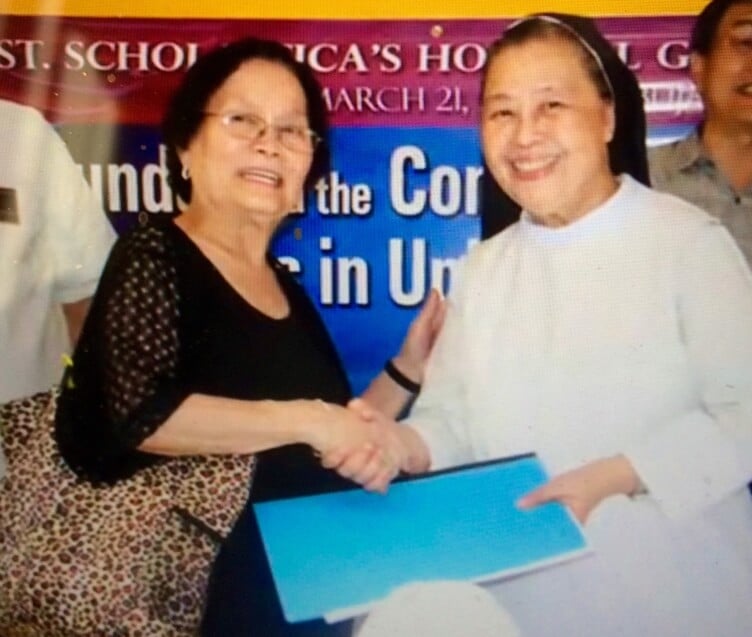 Mrs. Salazar presenting deed to Sr. Mary John Mananzan