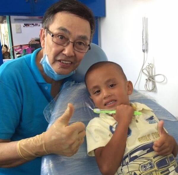 Dr. Ed de la Vega gives a thumbs up after examining a local village child.